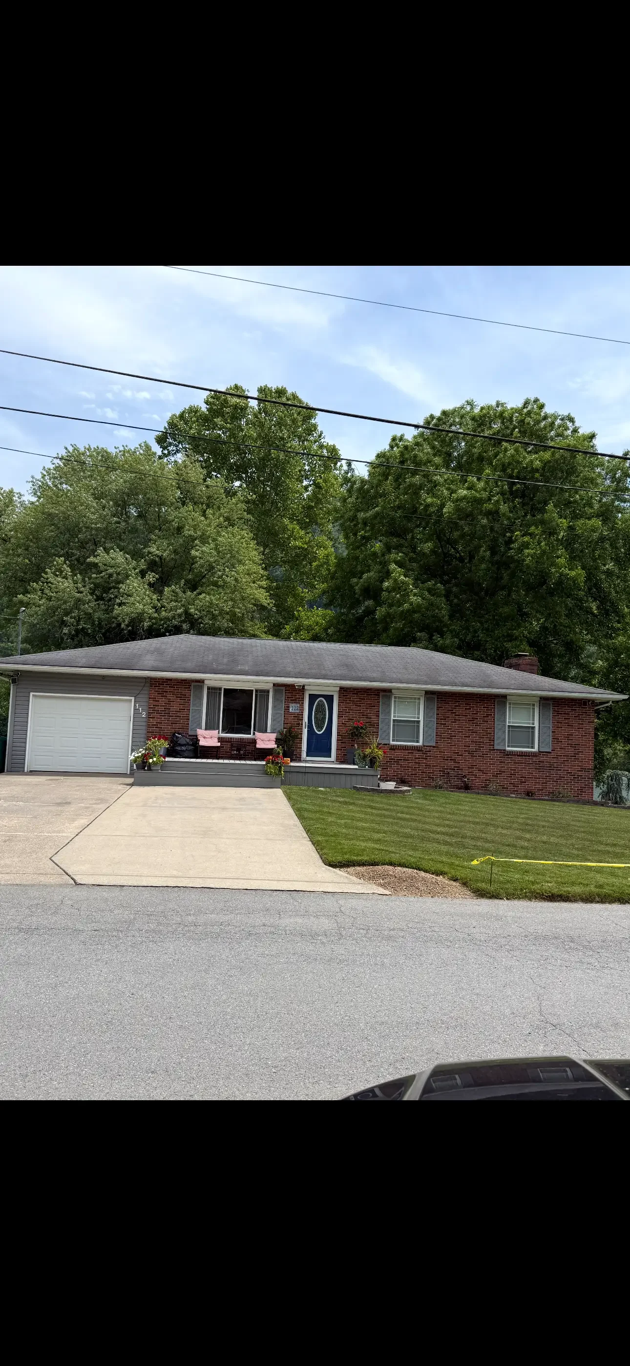 New asphalt shingle roof on brick ranch home with proper flashing and clean edges
