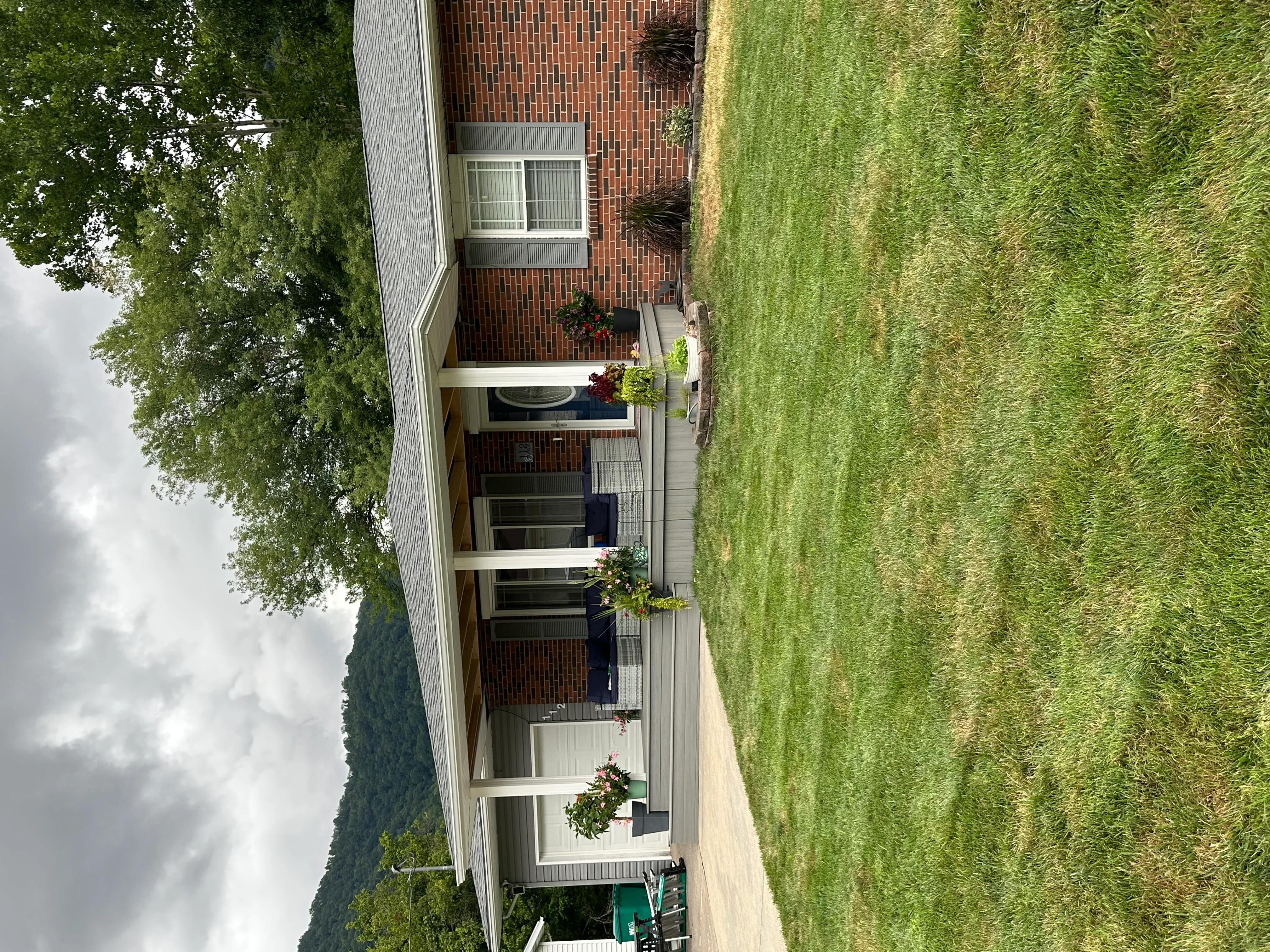 New asphalt shingle roof installed on brick residential home with chimney flashing